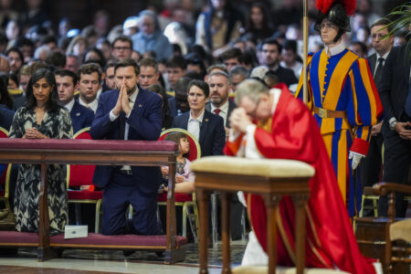U.S. Vice President JD Vance, and his wife Usha Vance, left, with their daughter Mirabel attend a Good Friday service led by Cardinal Claudio Gugerotti, right, inside St. Peter's Basilica at the Vatican. (AP Photo/Alessandra Tarantino)